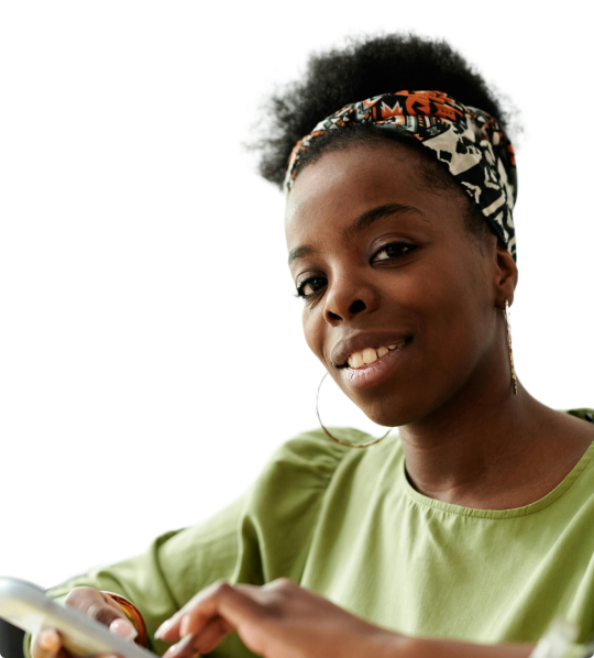 portrait of a woman smiling and holding a smartphone in her hand